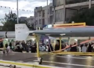 Iran paraded Shahed-136 drones through Tehran in major rallies supporting its armed forces. The display comes as the regime faces a U.S. naval blockade and continued military pressure, signaling resilience and asymmetric warfare capabilities