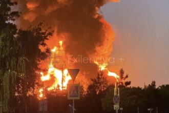 A massive fireball and thick column of dark smoke erupt into the twilight sky following a successful long-range Ukrainian drone strike on a critical Russian oil infrastructure facility. Source: Exilenova+/Telegram via The Kyiv Independent