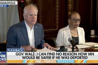 Minnesota Governor Tim Walz sits alongside Minnesota Supreme Court Chief Justice Natalie Hudson at a special meeting of the Board of Pardons. The broadcast covers the unanimous decision by the board to pardon Jai Vang a Laos native who had lived in Minnesota since childhood to prevent his imminent deportation by federal immigration authorities. Source: FOX & Friends Weekend / FOX News Channel Archive